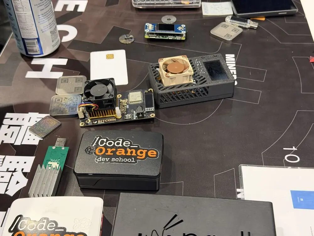 Bitcoin nodes, miners, and devices on a Code Orange workshop table