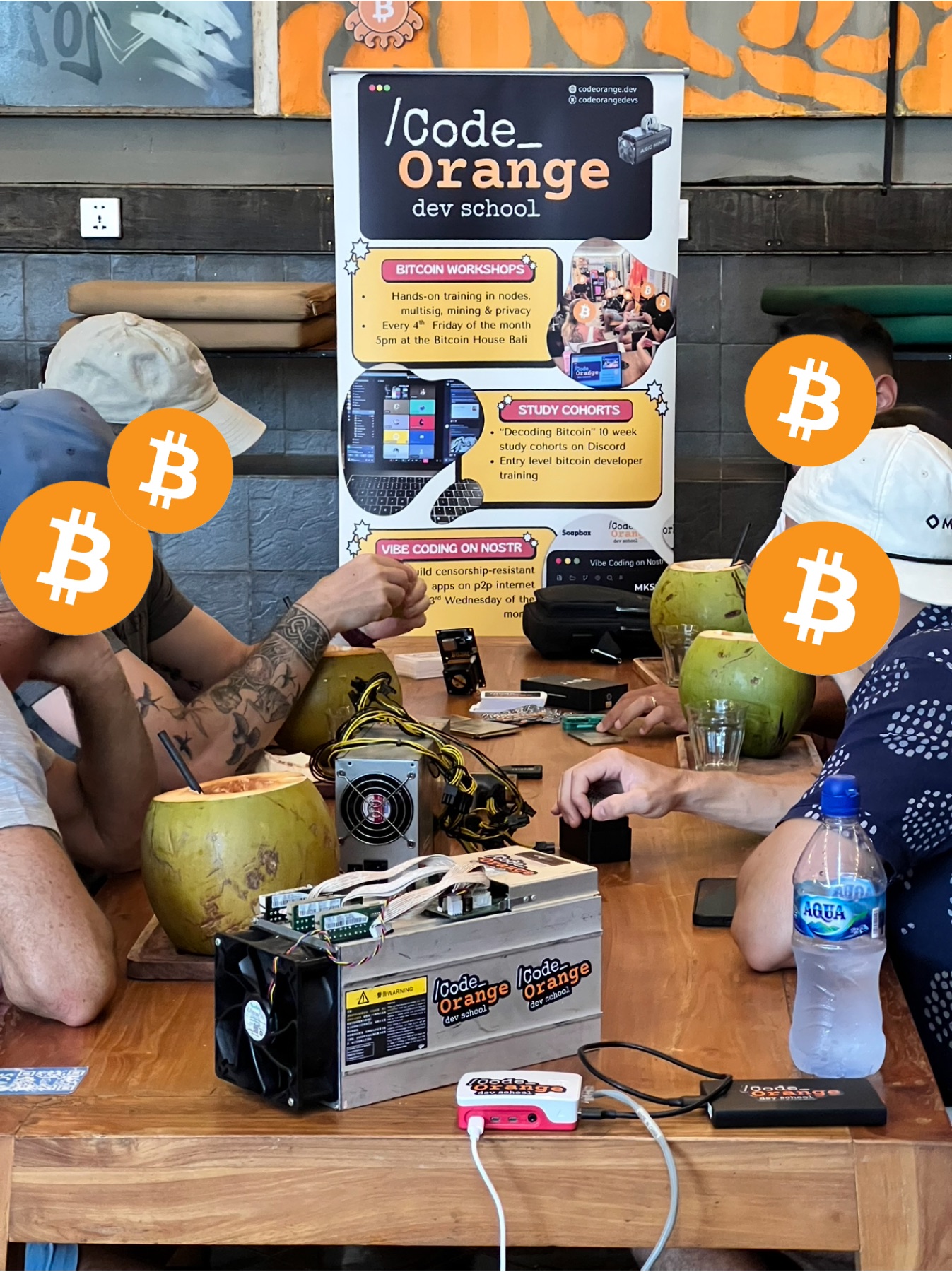 Code Orange workshop banner and ASIC miner on the table